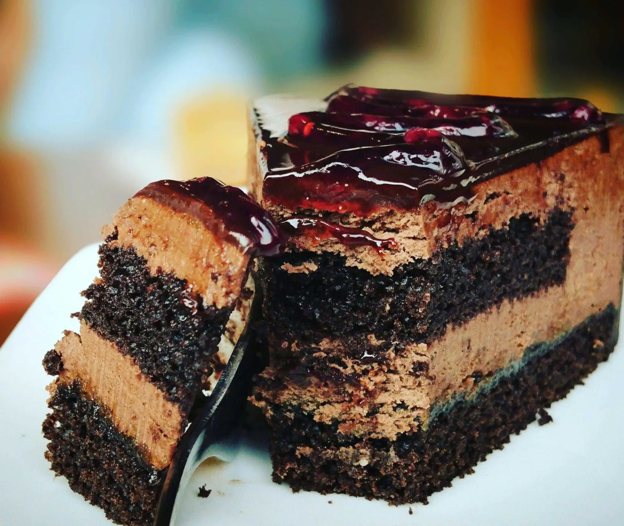 Layered chocolate cake with berry topping in cake boxes for quick service or pop-up events