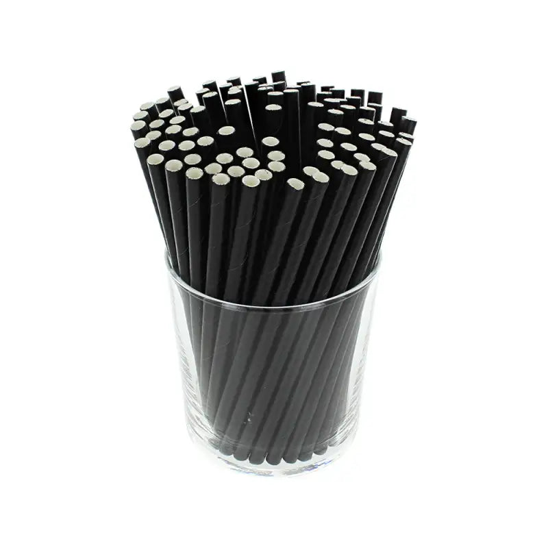 Bundle of black paper cocktail straws in a clear glass container for stylish serving