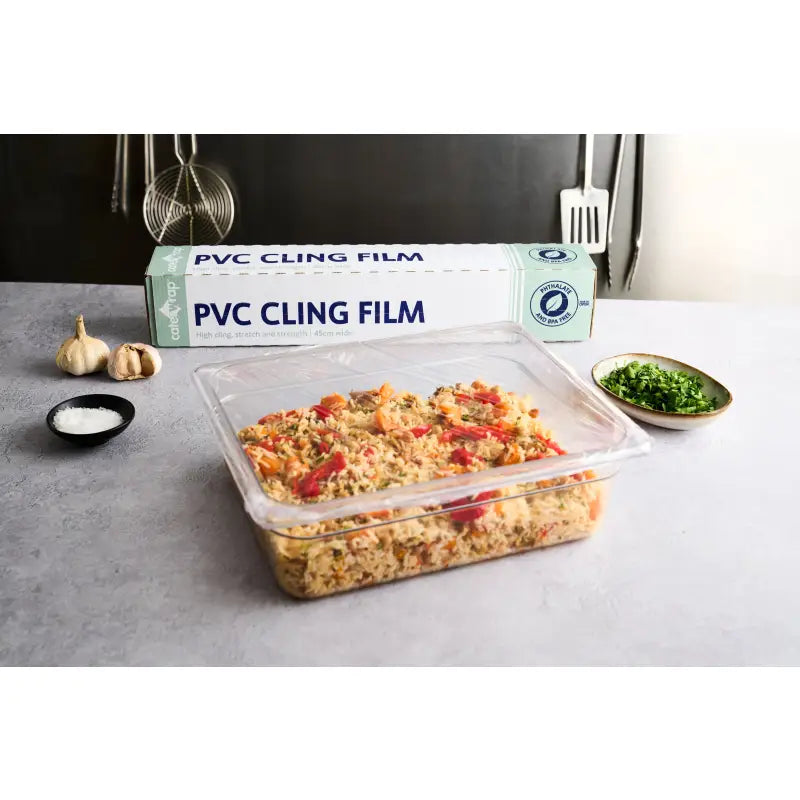 Prepared food in a plastic container covered with catering cling film and cutterbox dispenser