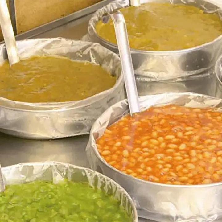 Metal containers with colorful sauces in Gastronorm Tray Liners for easy serving