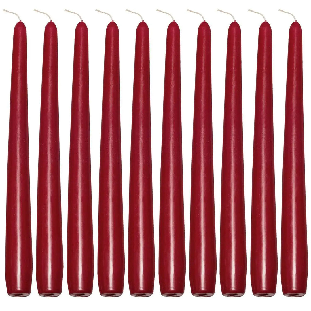 Row of tall, slender red taper candles for elegant dinner settings