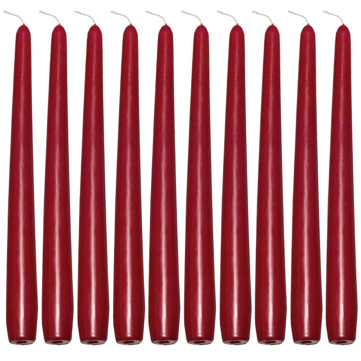 Row of tall, slender red taper candles for elegant dinner settings