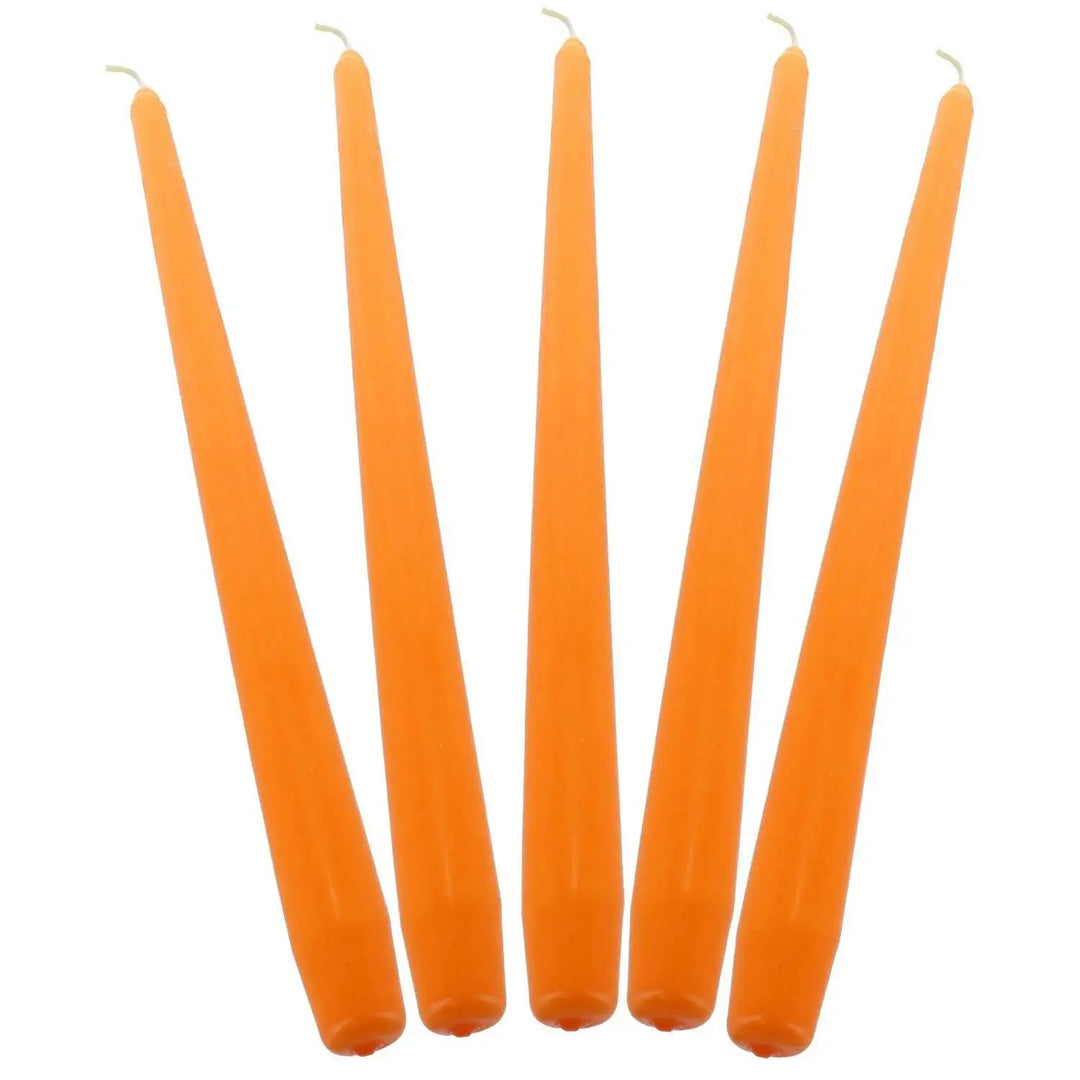 Five orange taper candles in a row for elegant dinner decor and ambiance