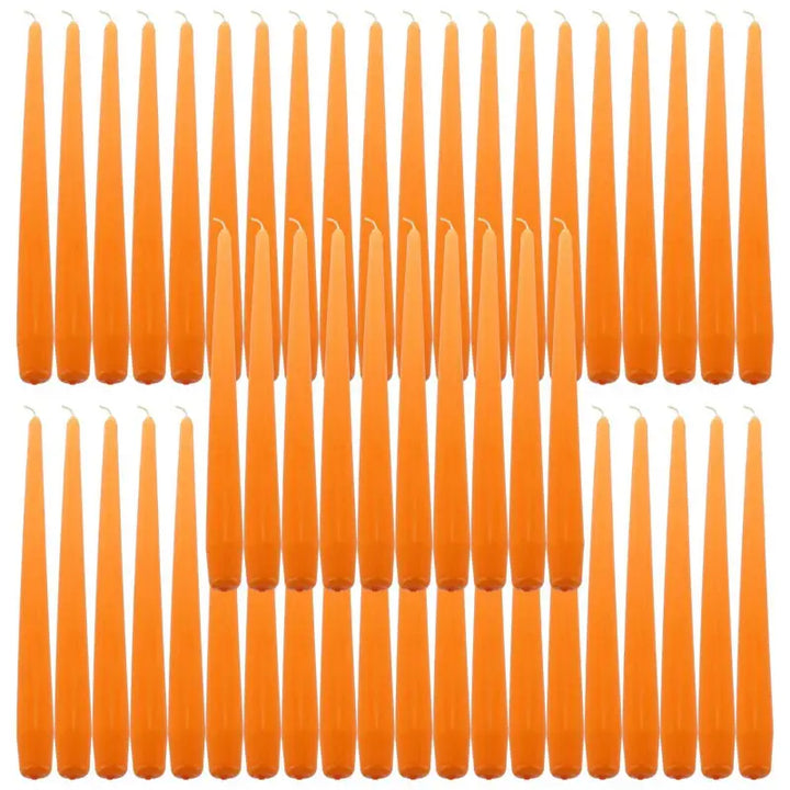 Orange taper dinner candles arranged in rows for elegant dining