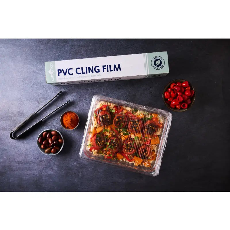 Prepared food in a plastic container covered with catering cling film and cutterbox dispenser