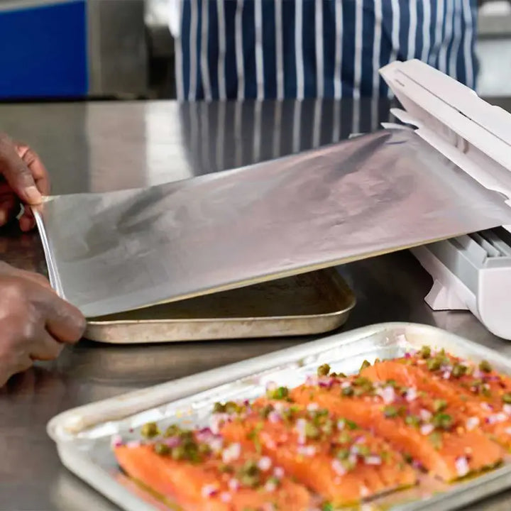 Salmon fillets with herbs on a tray, perfect for wrapping in Aluminium Foil 24C54