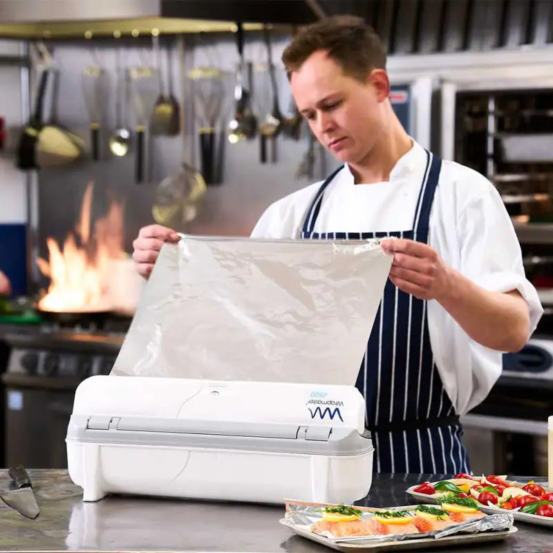 Chef in a white coat using kitchen appliance with Wrapmaster 4500 Aluminium Foil 24C55