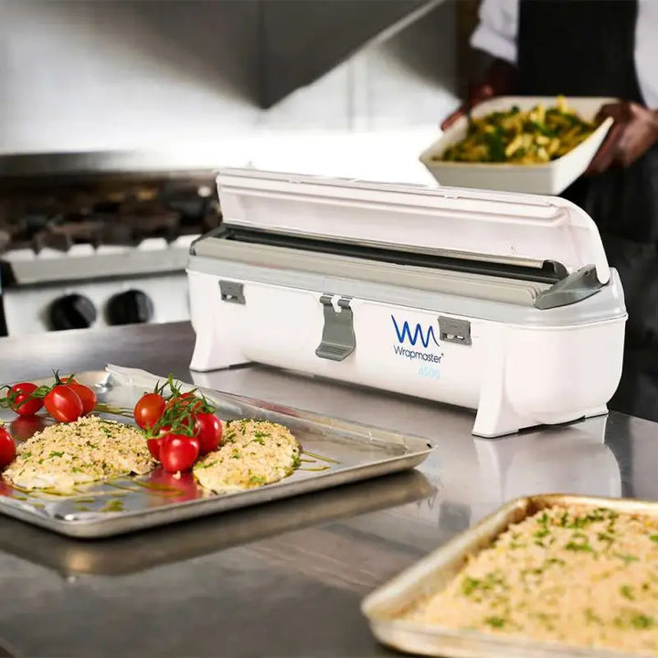 Wrapmaster 4500 Dispenser - 63M97 on kitchen counter with refill rolls for baking parchment